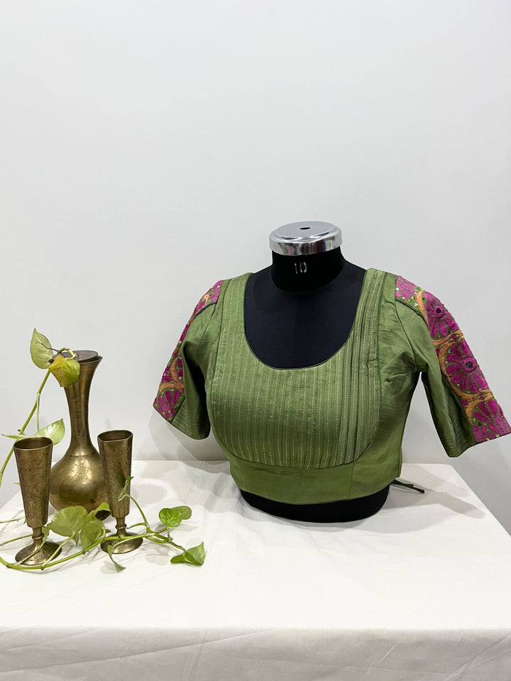 Mehndi green silk blouse with pleated front detailing and pink patch sleeves for festive and Navratri wear 