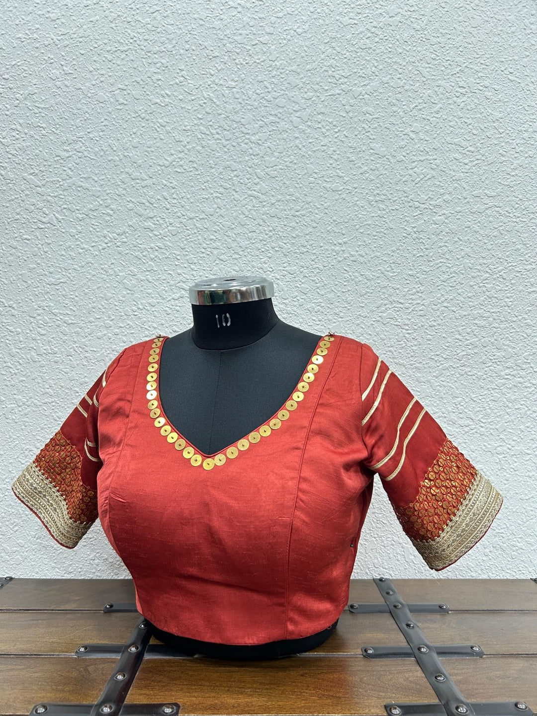 Red blouse with tiki work details in neckline and sleeve
