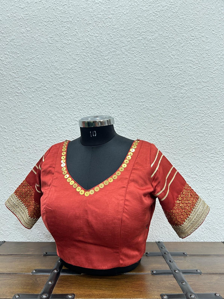 Red blouse with tiki work details in neckline and sleeve