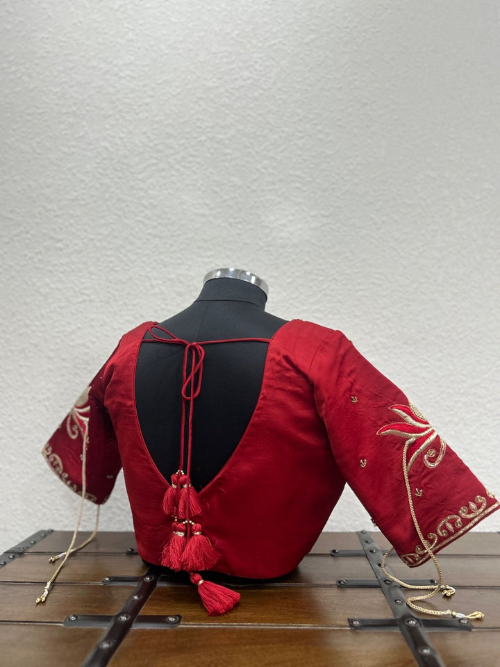 Festive raw silk blouse featuring handcrafted lotus-inspired embroidery and elegant detailing