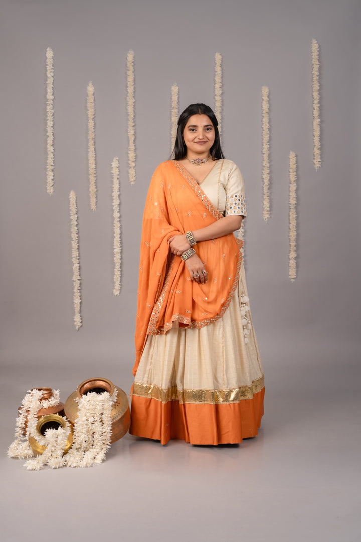Beige & light orange festive Navratri lehenga and blouse with mirror work and dupatta 