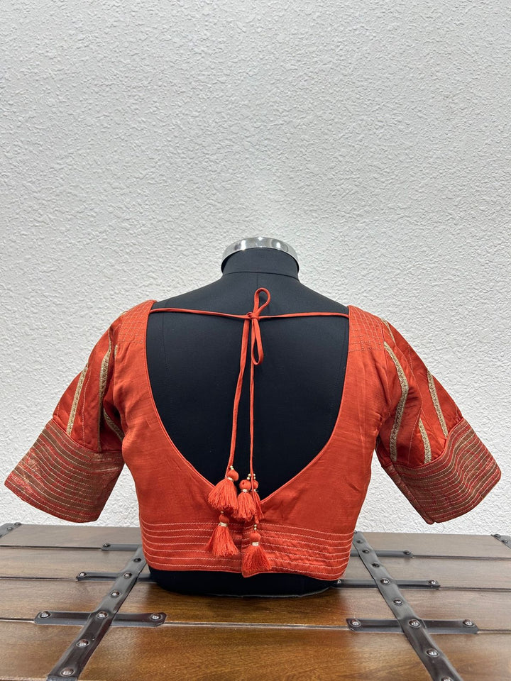 Festive designer blouse featuring Banarasi detailing and intricate kasab work on the sleeves