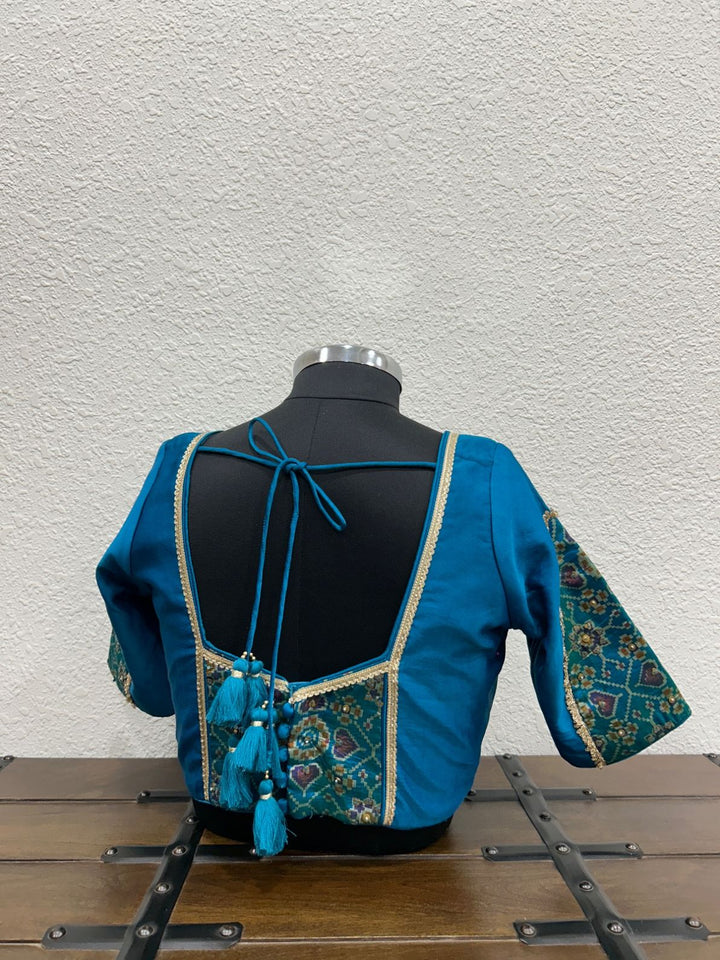 Designer ethnic blouse with delicate lace accents and traditional craftsmanship