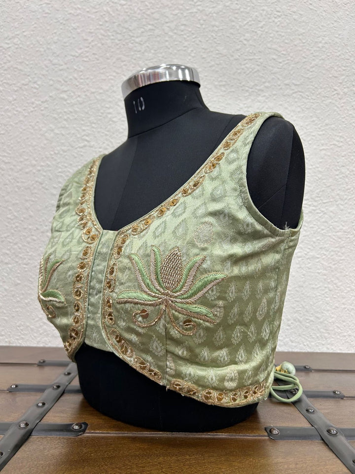
Designer festive blouse featuring elegant lotus hand embroidery and traditional craftsmanship