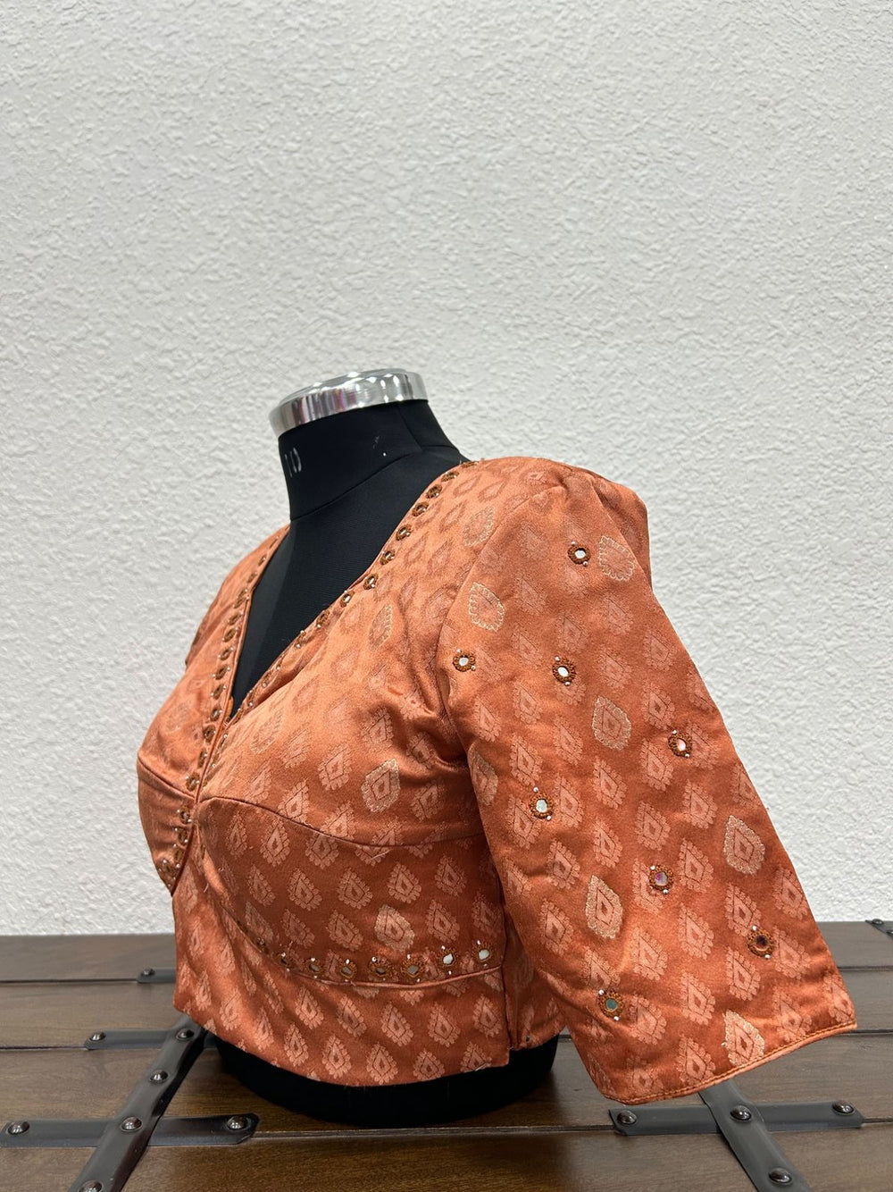 Festive designer blouse featuring mirror embroidered sleeves and handcrafted detailing.
