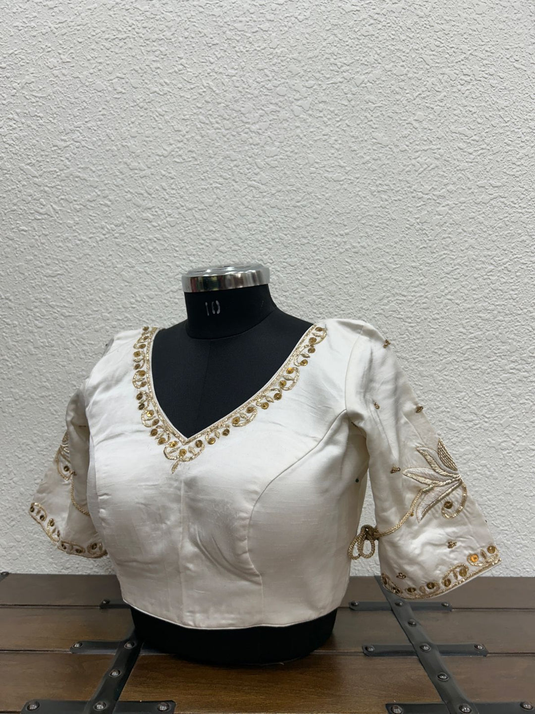 Elegant V-neck designer blouse with detailed hand embroidery and festive craftsmanship