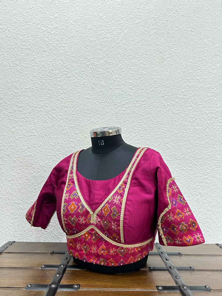  Festive designer blouse with Ikkat Patola front detailing and elegant lace neckline