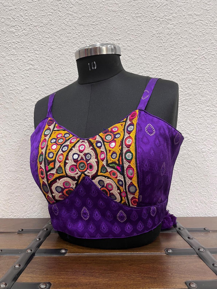 Sleeveless festive blouse featuring traditional Kutchi work embroidery
