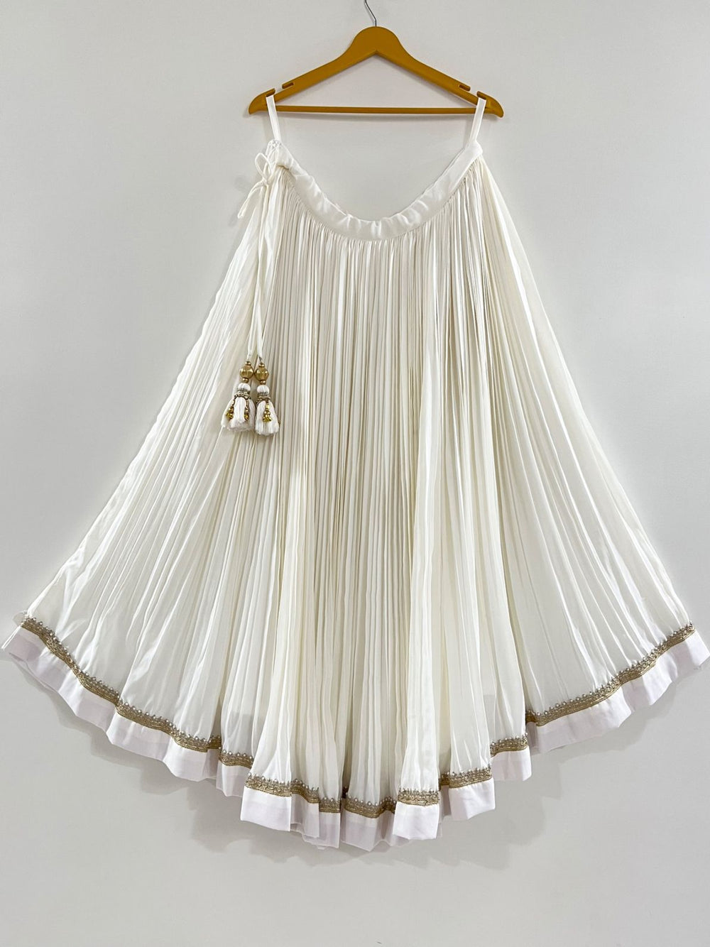 White pleated chaniya with golden lace perfect for puja function and navratri festive 