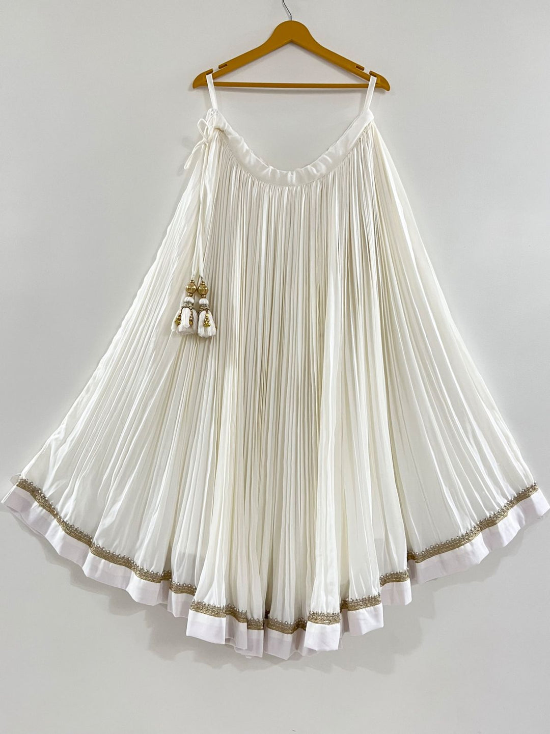White pleated chaniya with golden lace perfect for puja function and navratri festive 