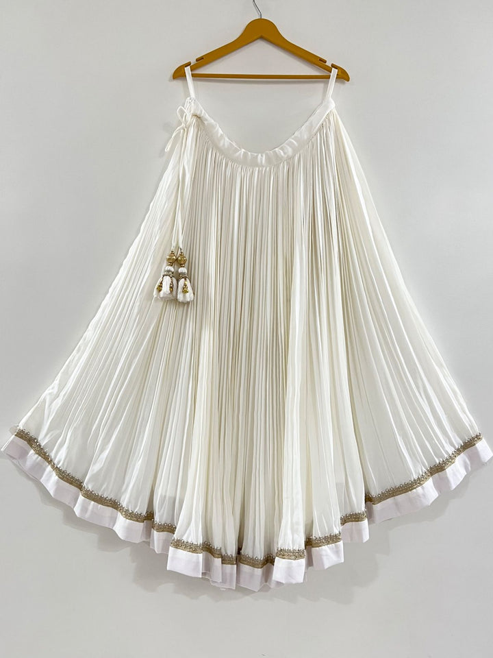 White pleated chaniya with golden lace perfect for puja function and navratri festive 