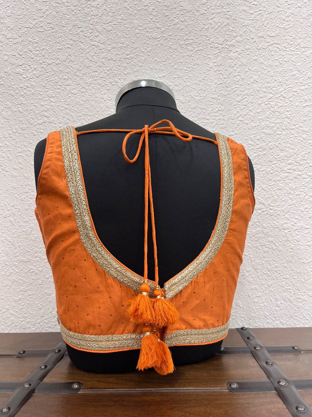 Designer orange festive blouse with handcrafted Mukesh work accents