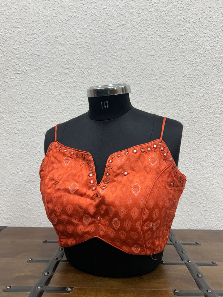 Orange Gajji silk blouse with intricate mirror embroidery detailing on neckline
