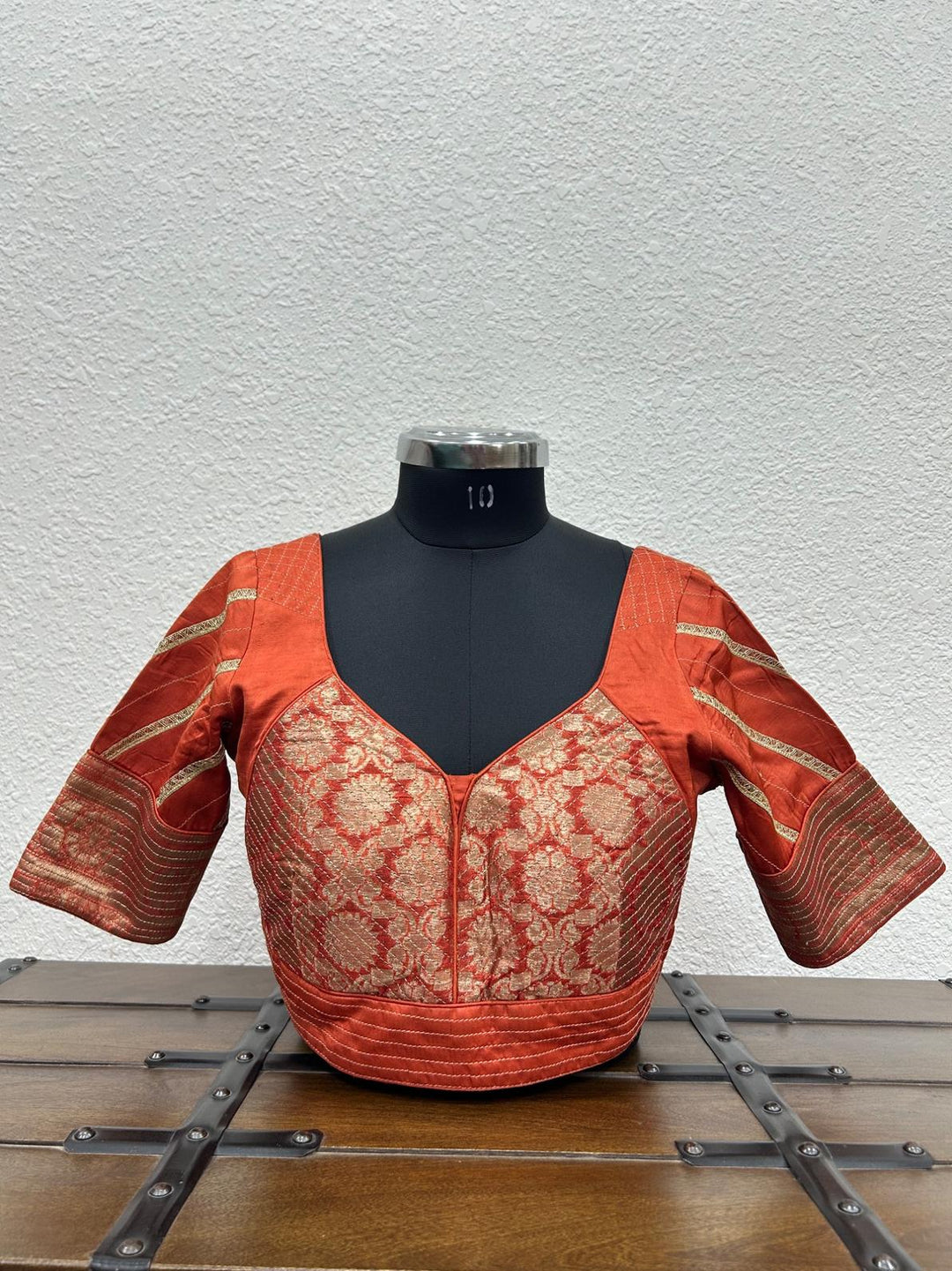 Orange raw silk satin blouse with Banarasi fabric and handcrafted kasab work on the front