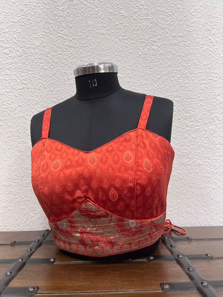 Orange red Banarasi corset blouse with kasab work border detailing