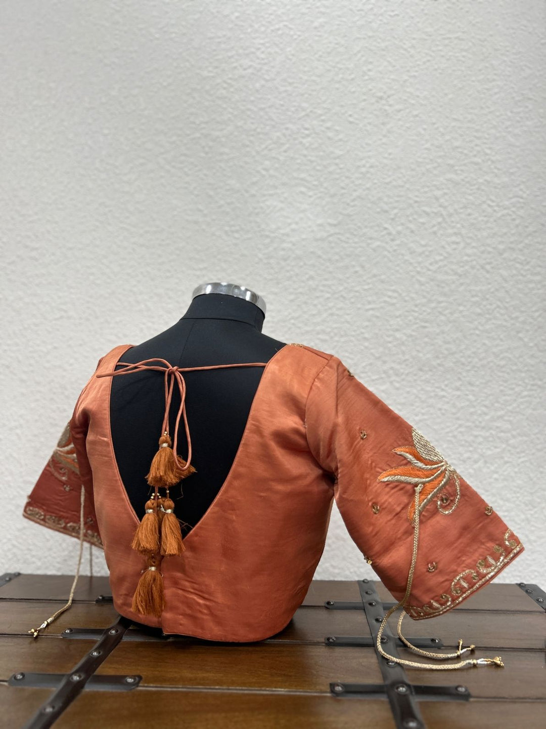 Premium ethnic blouse crafted in raw silk with detailed festive handwork