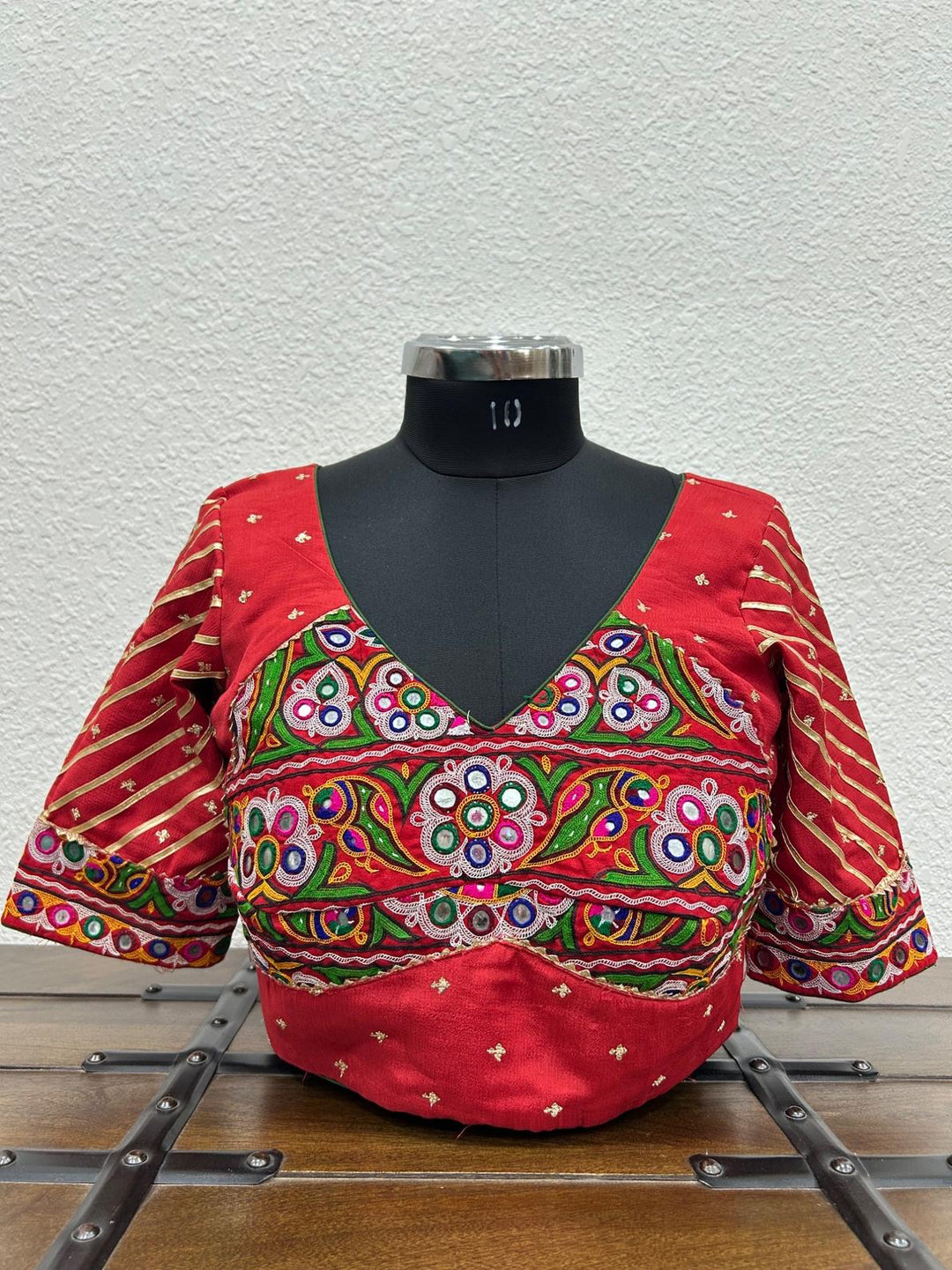 Red Chinon chiffon blouse featuring handcrafted Kutchi work on the front and sleeves