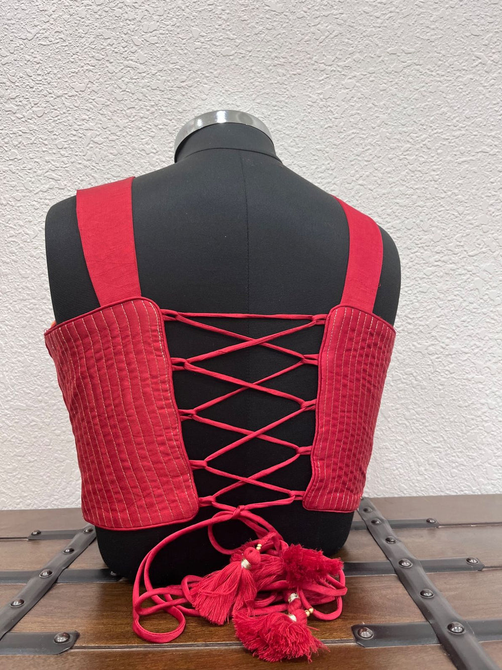 Designer red Navratri blouse with embroidered straps and criss cross dori back