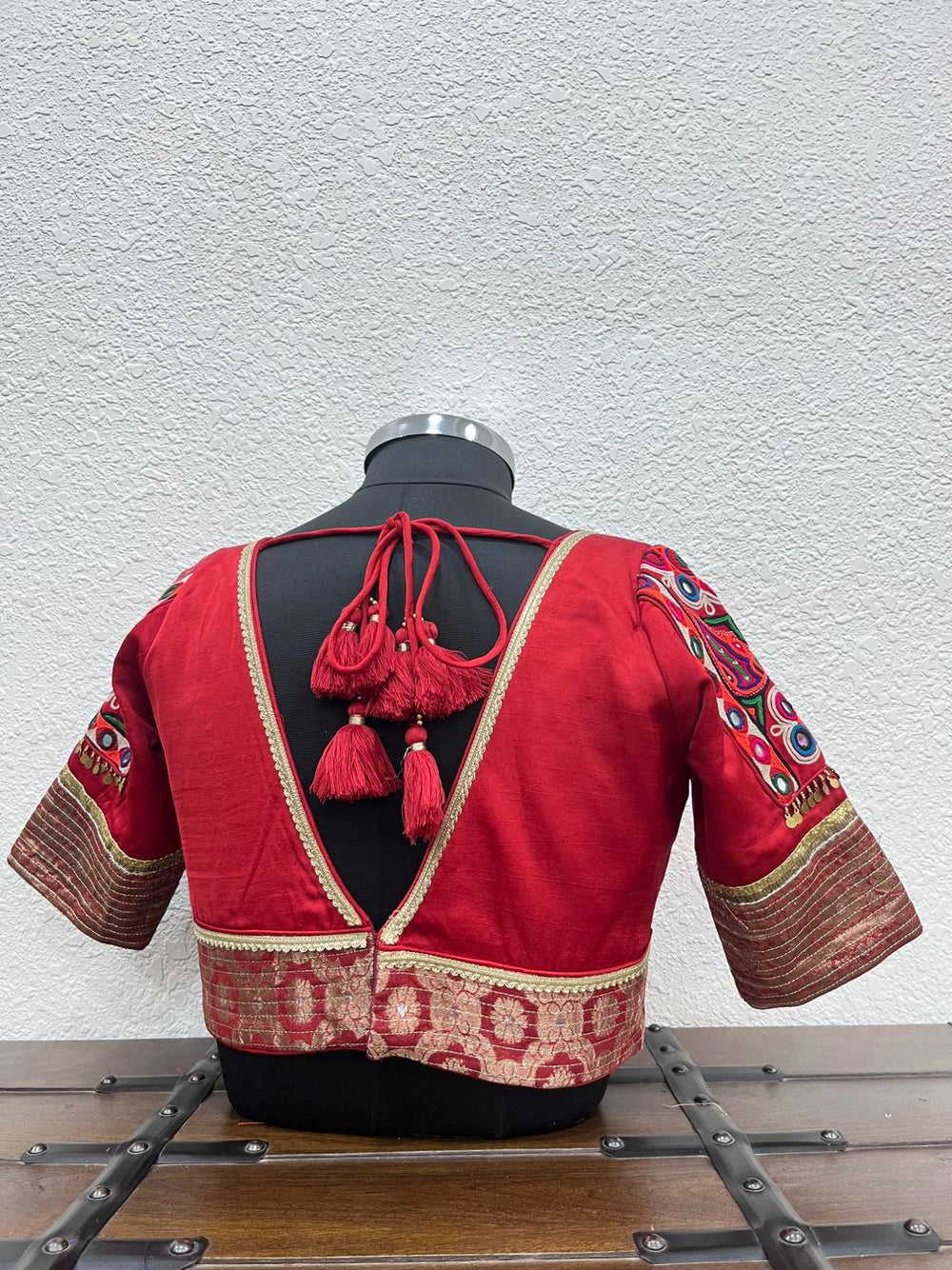 Designer red Navratri blouse with Kutchi patch sleeves and coin detailing
