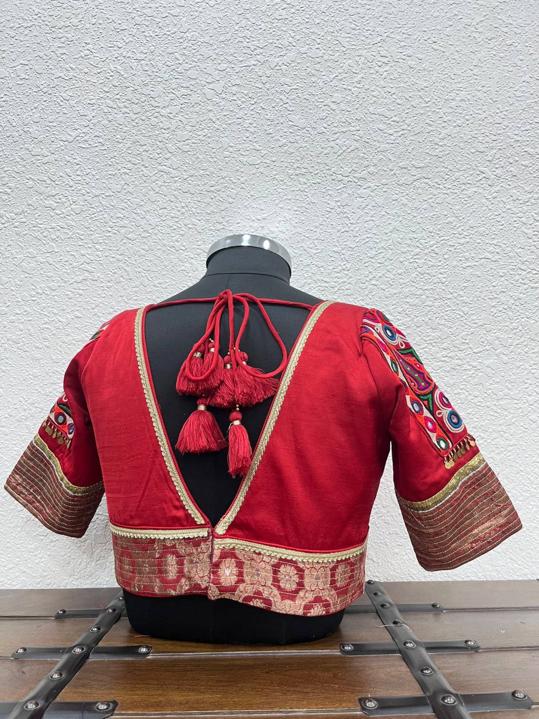 Designer red Navratri blouse with Kutchi patch sleeves and coin detailing
