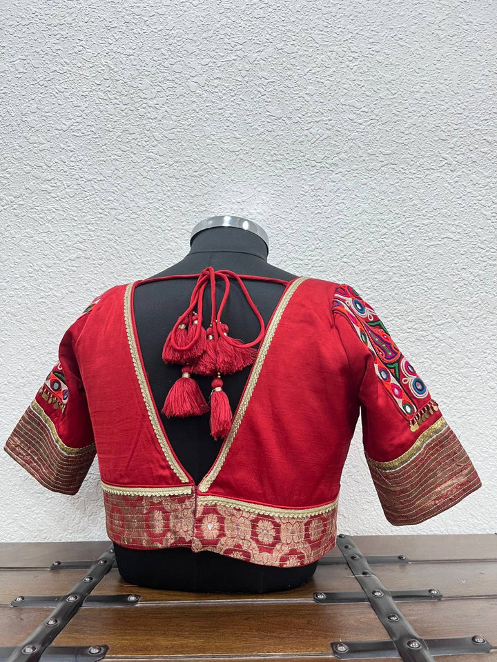Designer red Navratri blouse with Kutchi patch sleeves and coin detailing
