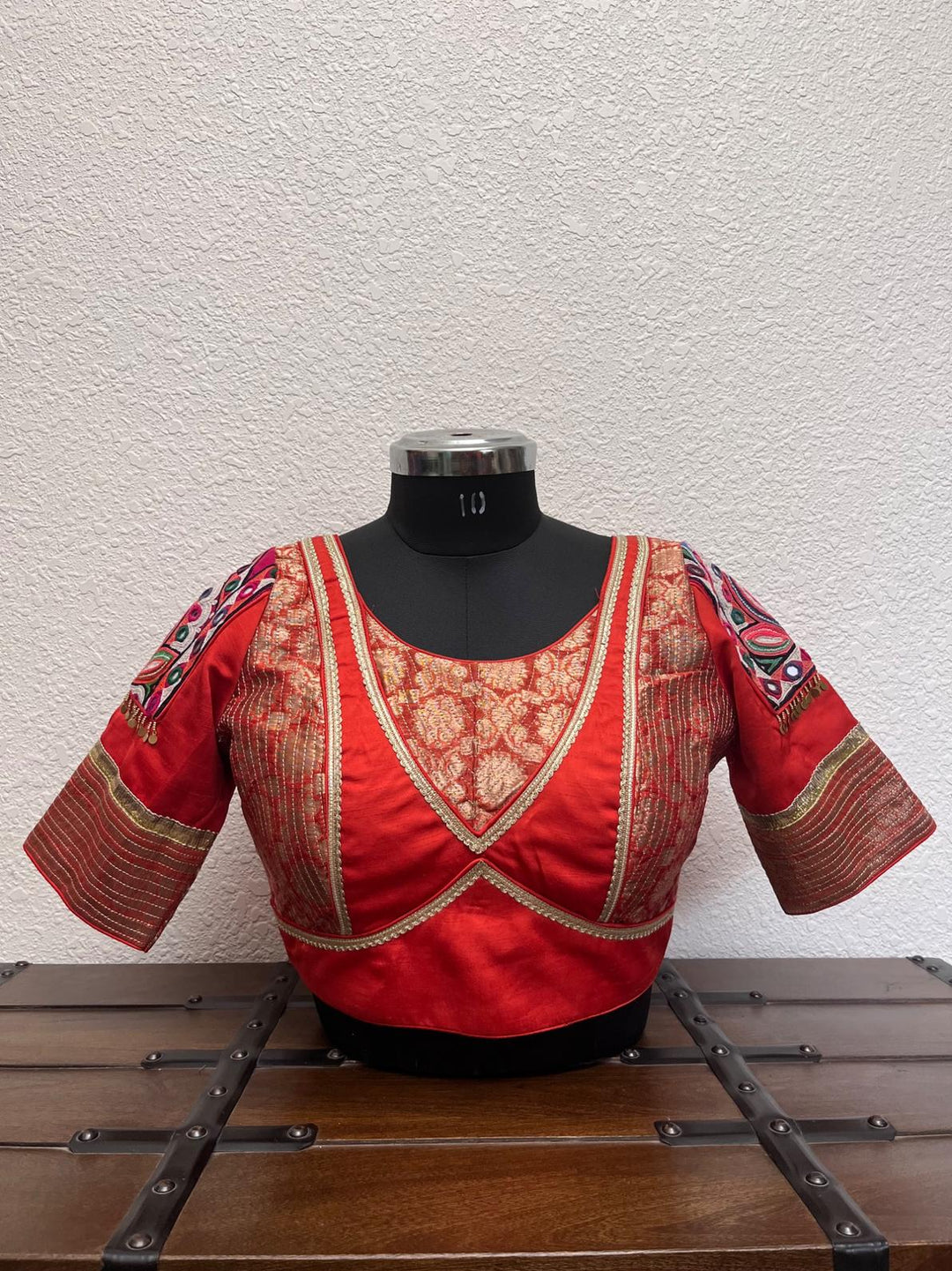 Rust Banarasi blouse with kasab embroidery, Kutch patch sleeves, and golden border detailing