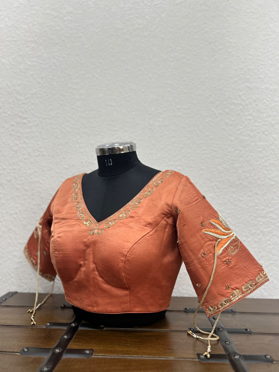 Rust raw silk designer blouse with intricate khat work on neckline and sleeves