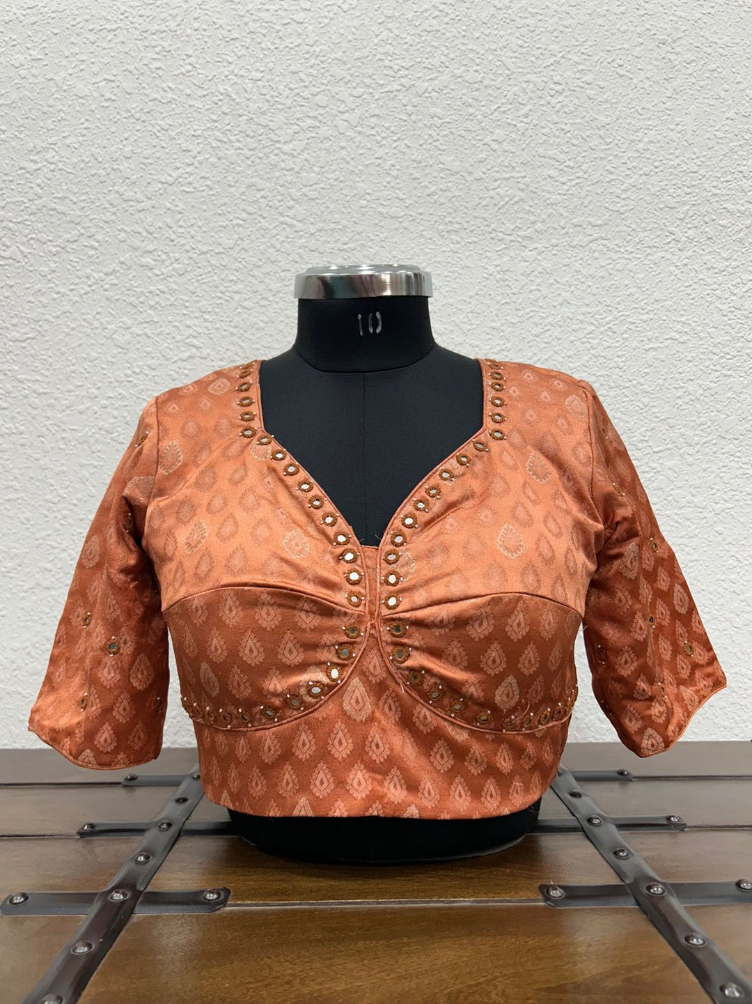 Premium Gajji silk blouse with handcrafted mirror work embroidery on the front.