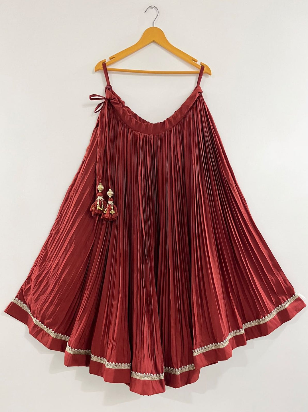 Rust pleated skirt with golden border navratri wedding function pohi studio ahmdabad 