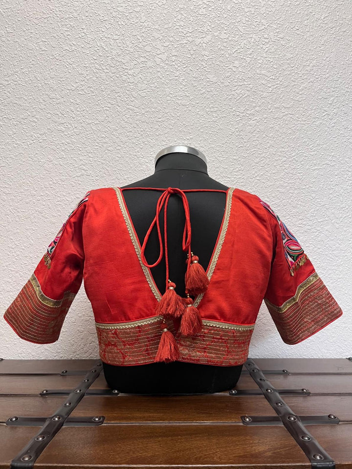 Rust Banarasi blouse with kasab embroidery, Kutchi patch sleeves, and golden border detailing