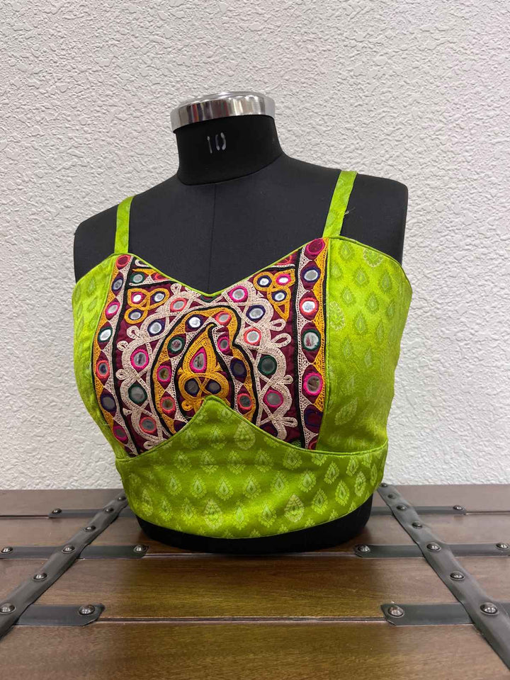 Traditional festive blouse with mirror-inspired Kutchi embroidery detailing
