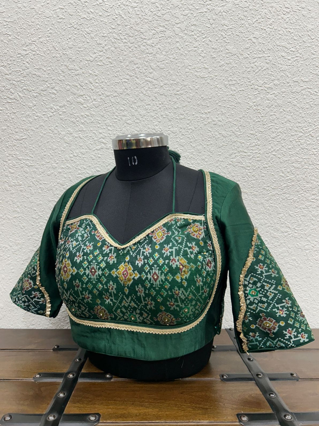 Festive blouse featuring coordinated Patola sleeve detailing and elegant finish