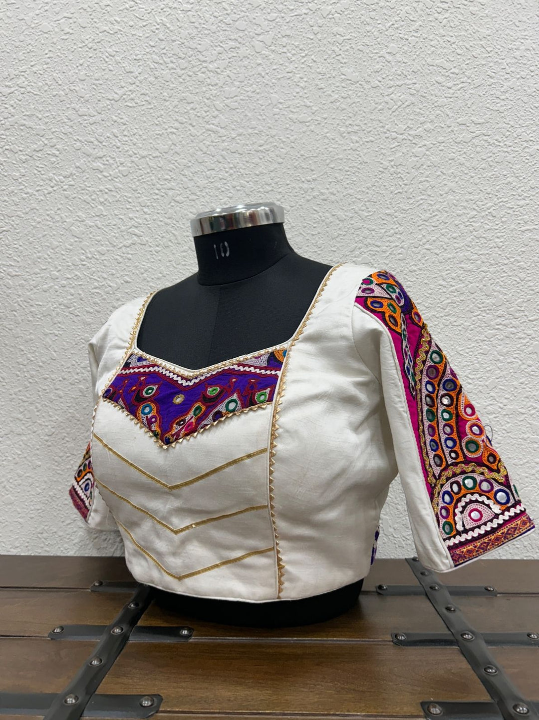 White raw silk satin blouse with vibrant Kutchi patch detailing and lace accents