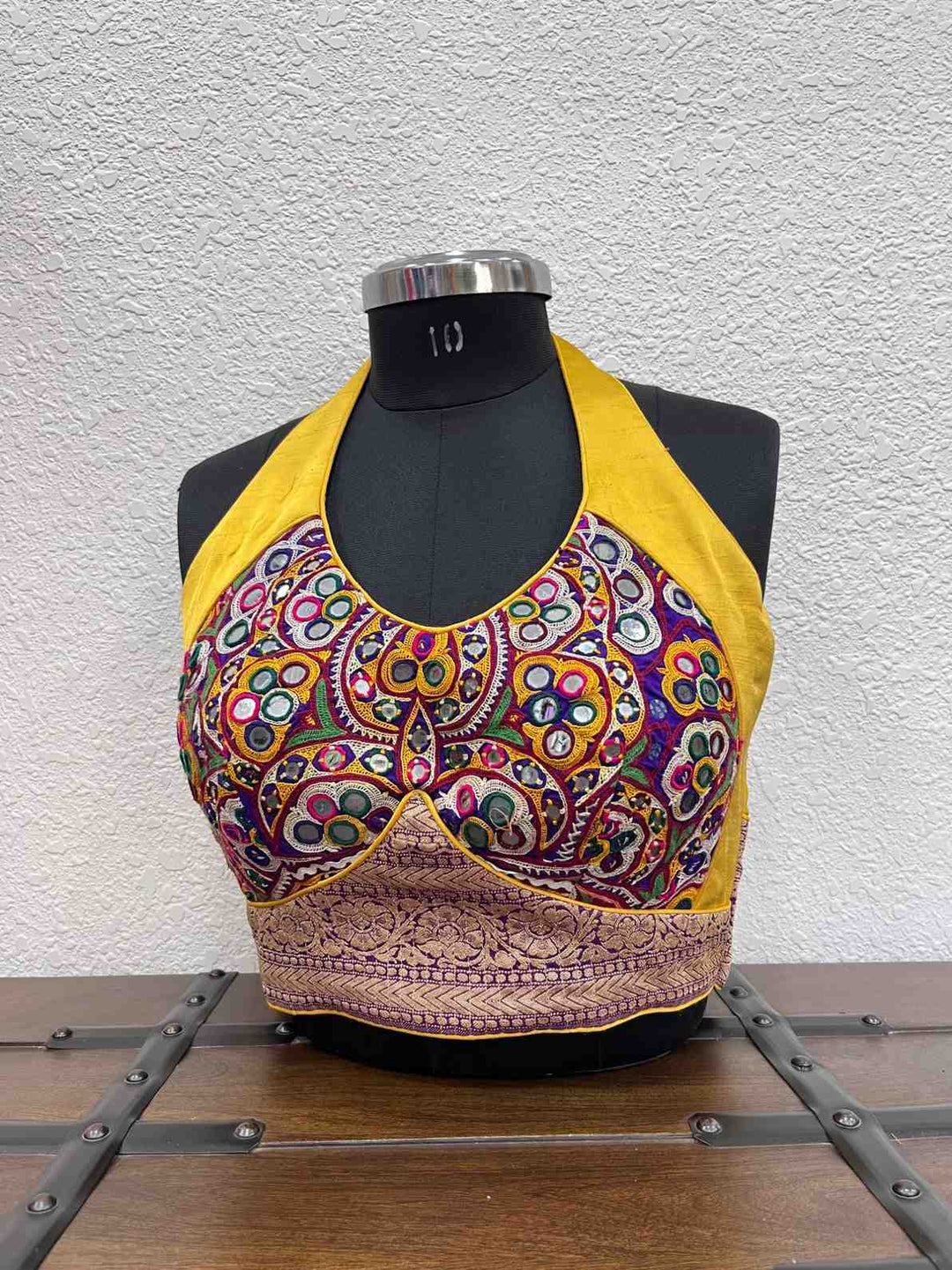 Yellow halter neck blouse with Kutchi mirror work and Banarasi border
